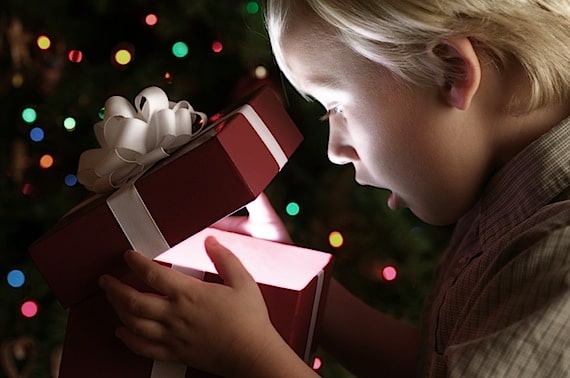 Little Boy Opening Christmas Present - Photo courtesy of ©iStockphoto.com/skodonnell, Image #2575217