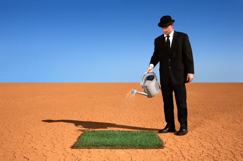 Businessman Watering Grass in the Desert - Photo courtesy of ©iStockphoto.com/skodonnell, Image #7597823